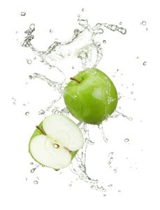 fresh green apples in a splash of water