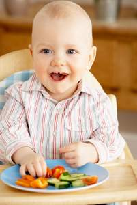 cute toddler snacking on vegetables