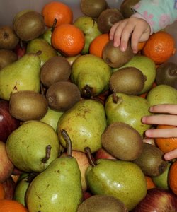 kid reaching for fruit