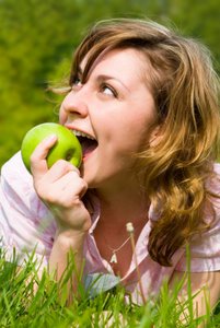 woman enjoying eating apple