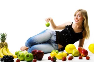 woman reclining amongst delicious fruit