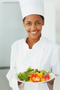 smiling chef holding healthy salad