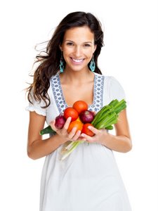 smiling woman holding vegetables