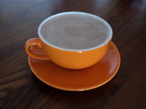 raw coffee in orange cup